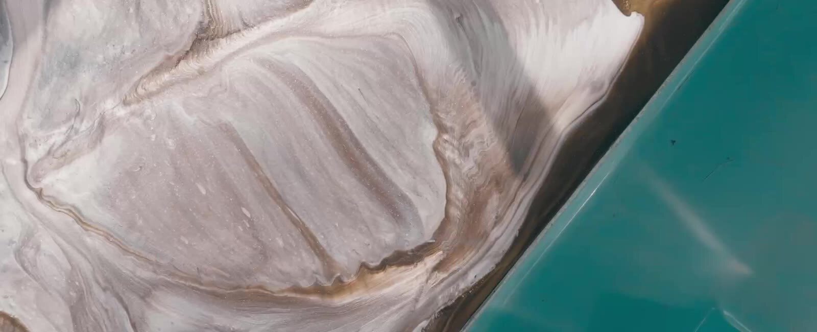 Metallic epoxy floor with a deep swirled finish