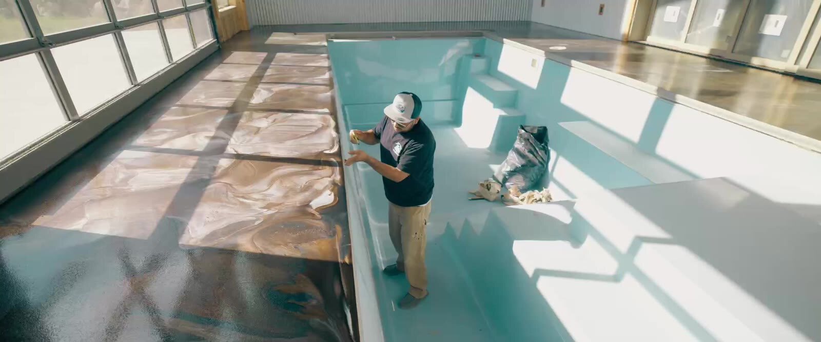 Teal metallic epoxy floor being revealed
